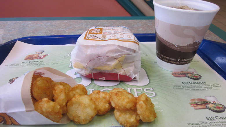 Burger King breakfast sandwich, beverage, and hash browns.