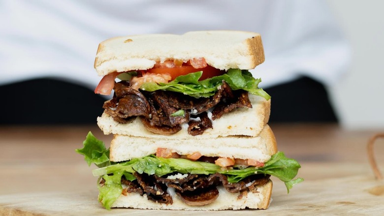 A meat mushroom vegan bacon sandwich on white bread