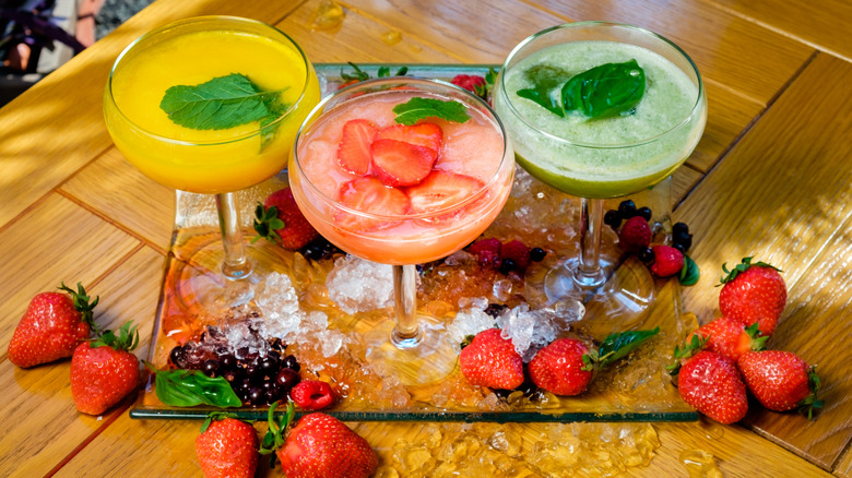 various frozen cocktails and ingredients on table