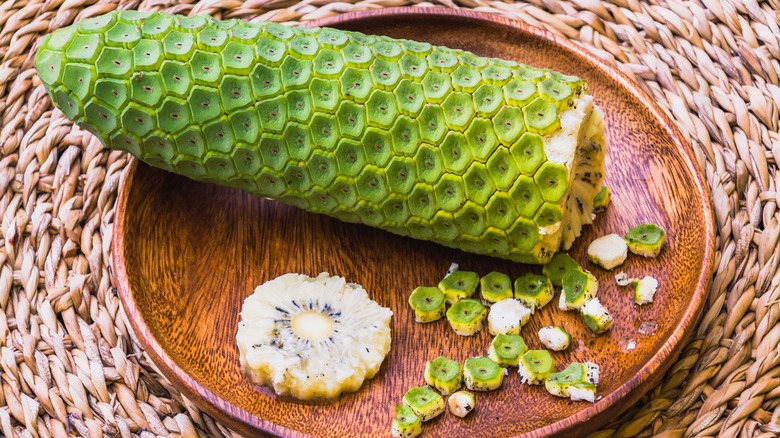 "Monstera deliciosa" fruit on a wooden plate