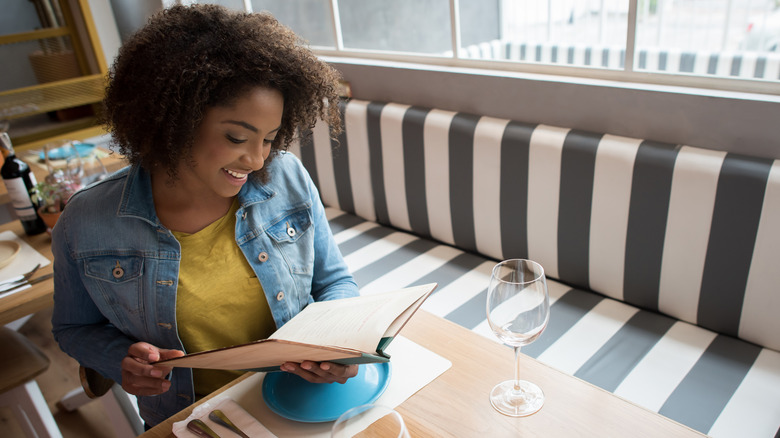 Person reading menu at restaurant