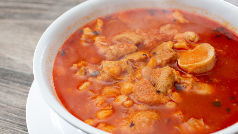 A bowl of menudo sitting on a table