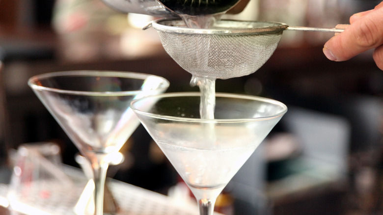 Straining martini into glass