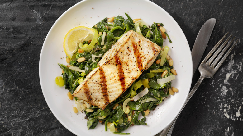 grilled fish fillet on salad