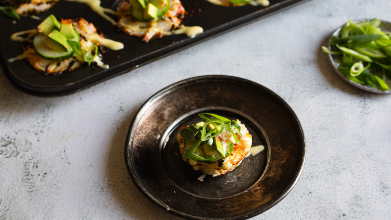 Small plate with an individual sushi muffin and more in background