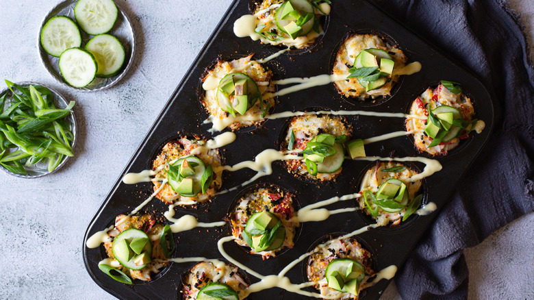 Mini sushi bake muffins in a pan with napkin and toppings