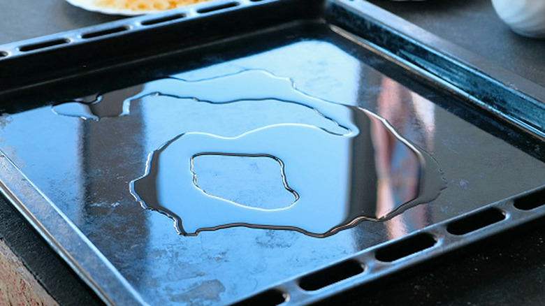 Cooking oil pools on a baking tray
