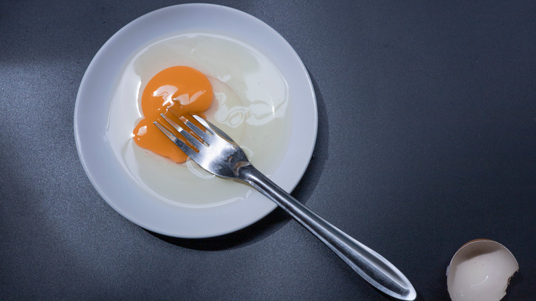 fork piercing egg yolk