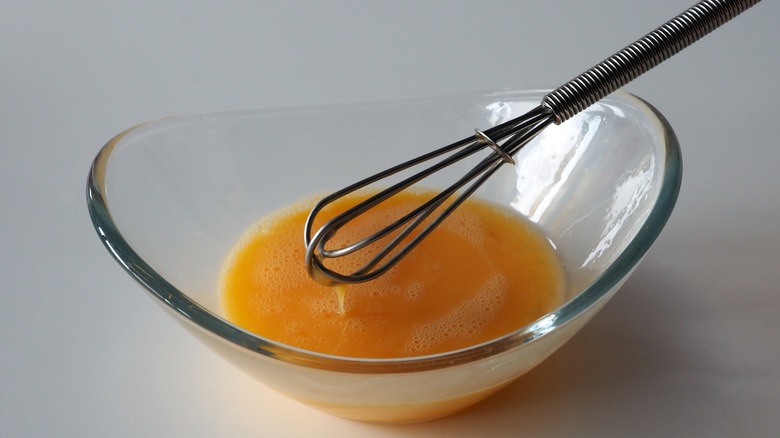 eggs in bowl with whisk