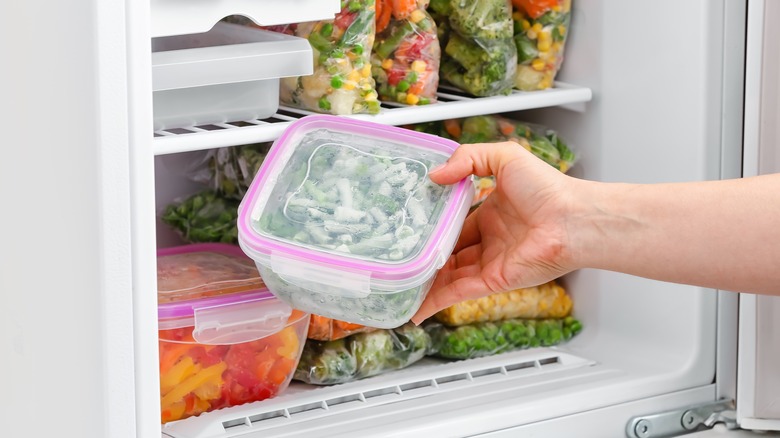 person removing beans from freezer