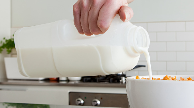 person pouring milk