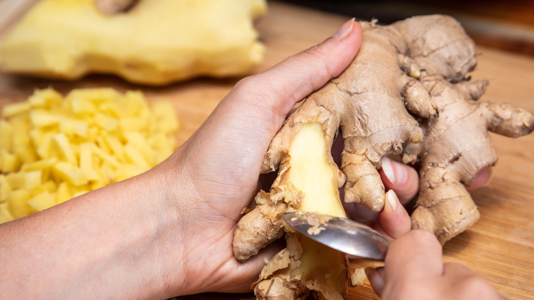 peeling ginger with a teaspoon