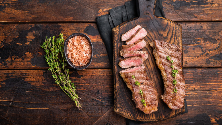 Tri-tip steak with salt and rosemary at the side