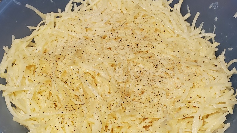bowl of raw, shredded potatoes