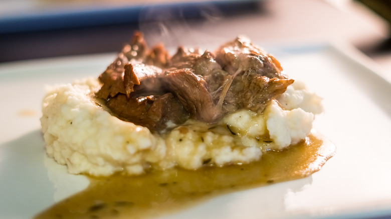 Pot roast with mashed potatoes and gravy on a plate