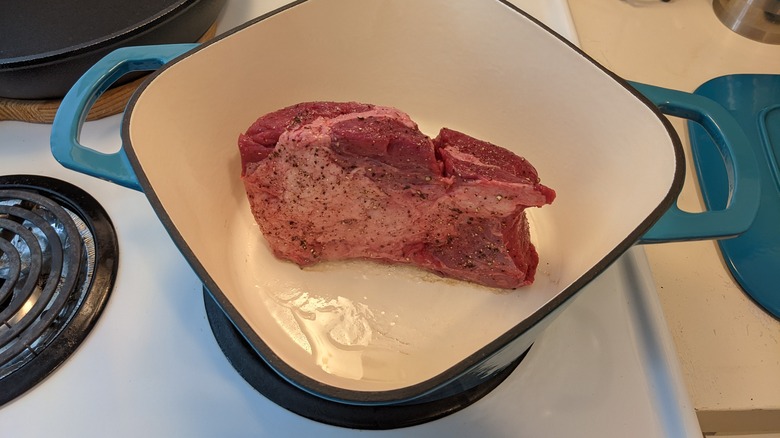 Piece of beef about to be braised in a Dutch oven