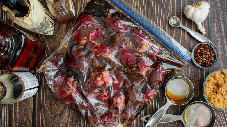 raw beef marinating in plastic bag