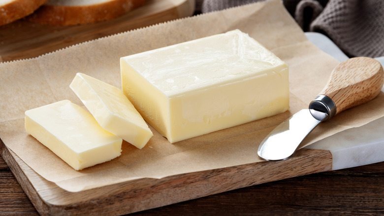 slices of butter on a wooden cutting board