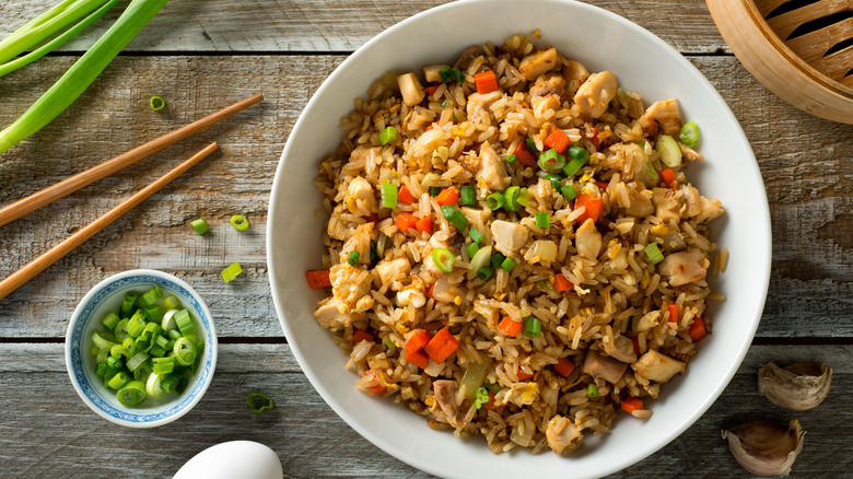 Bowl of fried rice on wooden table