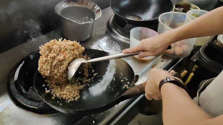 cooking fried rice in a wok