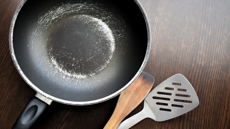 Scratched non-stick pan and metal spatula