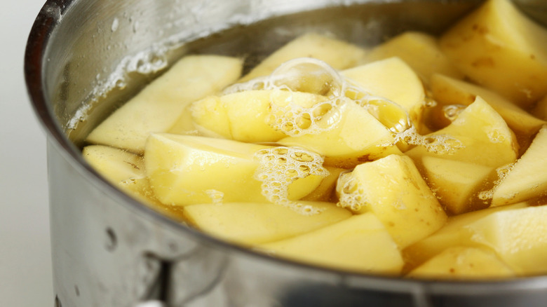 boiling pot of diced potatoes 