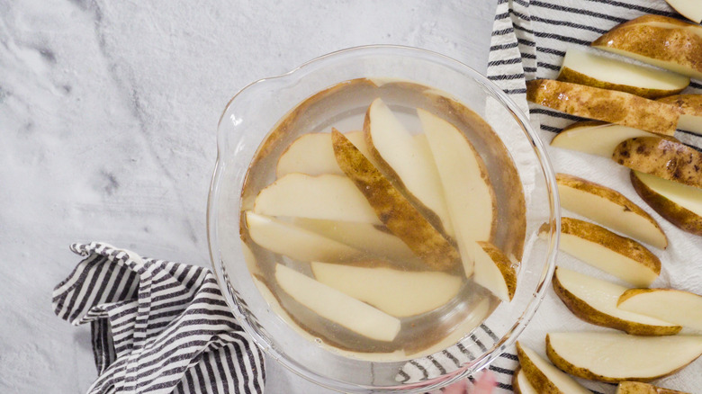 potato wedges soaking in water