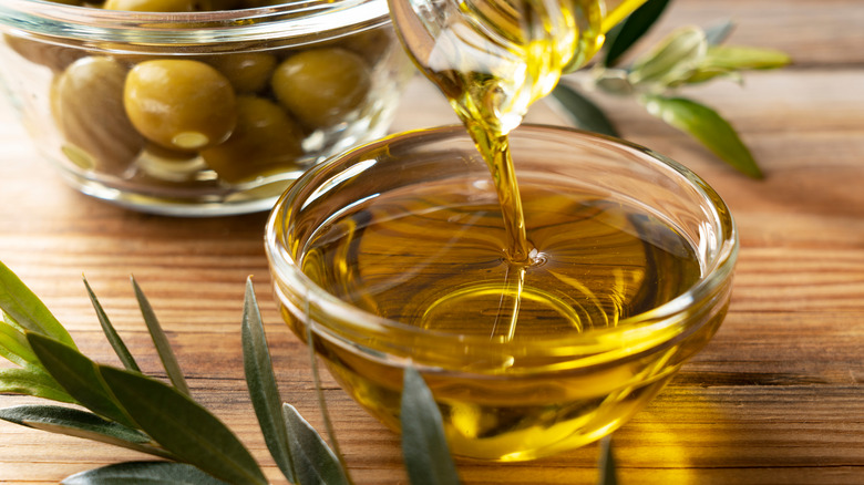 olive oil pouring into a bowl