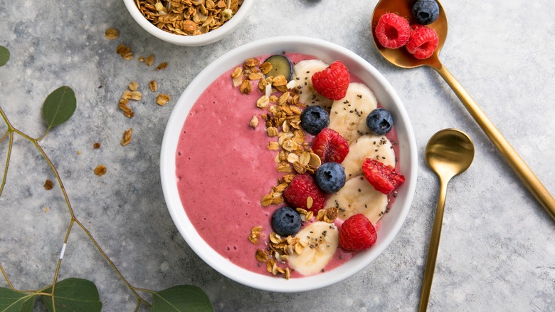 Acai bowl topped with fresh fruit and granola