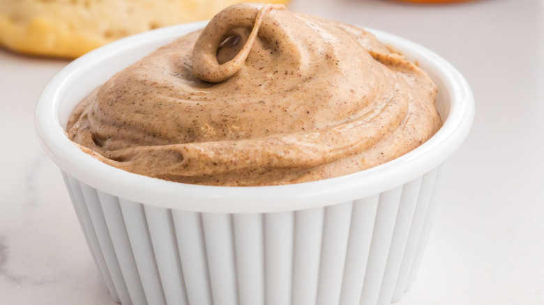 Upclose shot of cinnamon honey butter in a white ramekin