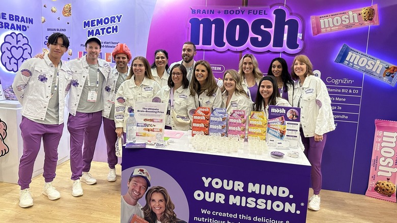 Members of the Mosh team, including cofounder Maria Shriver, are photographed at their booth during the Expo West 2025 trade show