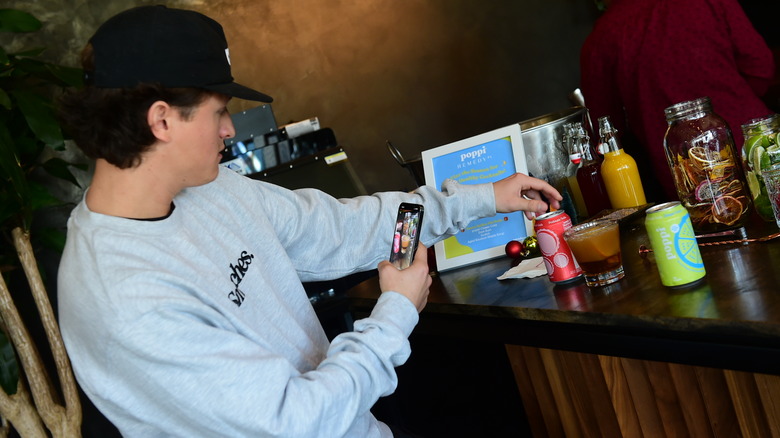 Connor Wood photographing poppi soda