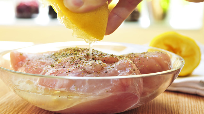 Chicken breast being marinated.