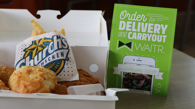 A box of Church's chicken, fries, and biscuit