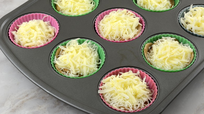 Muffin tins with shredded cheese