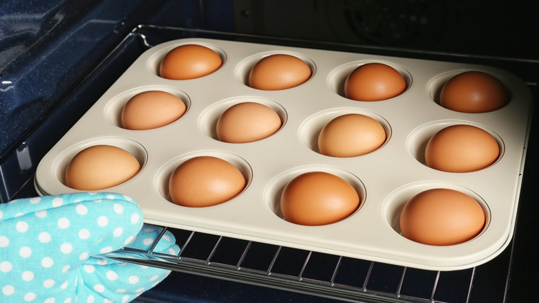 Muffin tin with eggs going into the oven