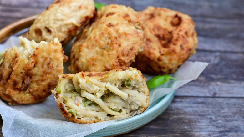 A basket of frittatina di pasta with one cut open