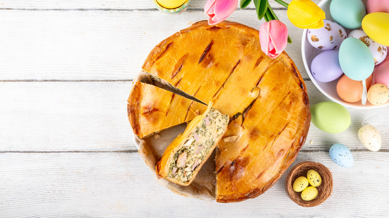 Italian Easter pie beside colorful Easter eggs