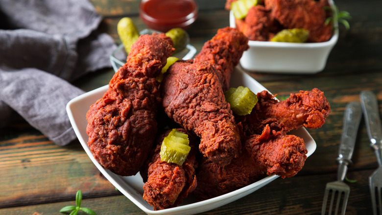 Nashville Hot Chicken served in a white bowl with pickles