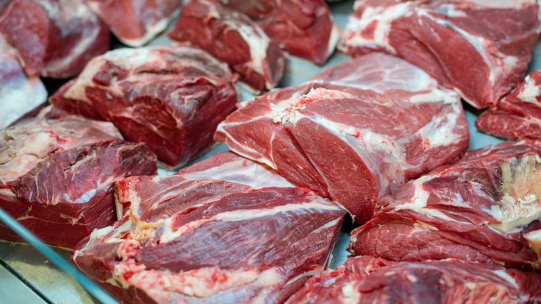 Roasts on display at a butcher's counter