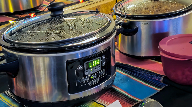 A slow cooker on a kitchen counter top.