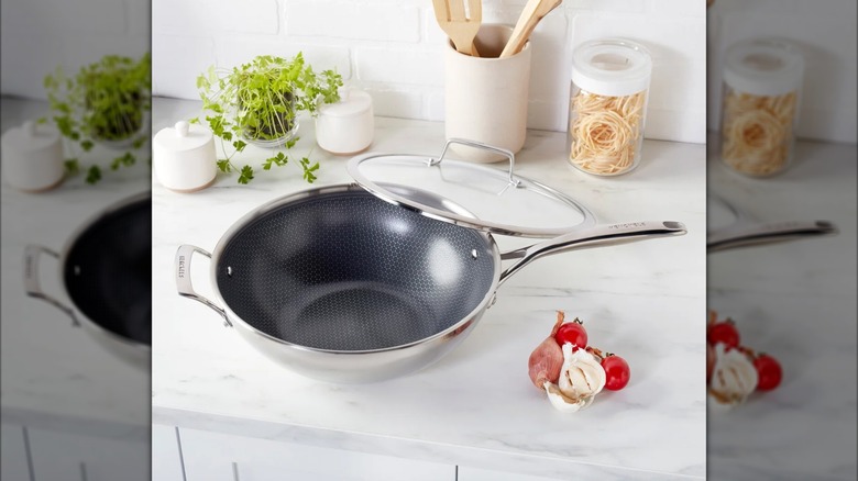 The Henckels Paradigm Ceramic 12-inch Work with Lid on a kitchen counter.