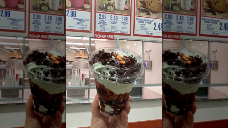 Someone holds the double chocolate mint sundae.