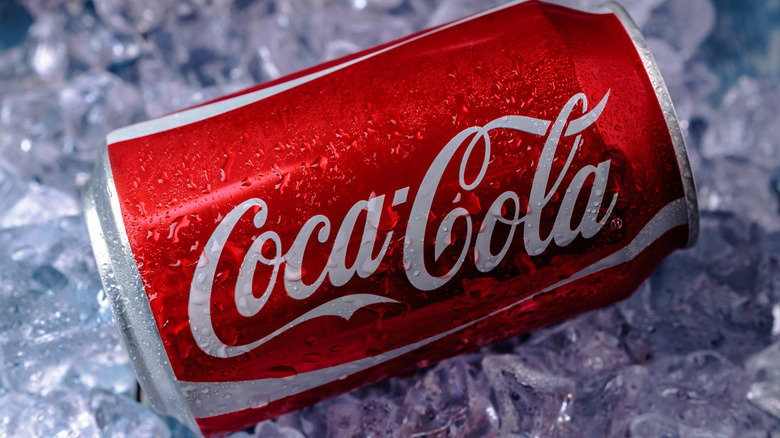 A can of Coke sitting on a bed of ice