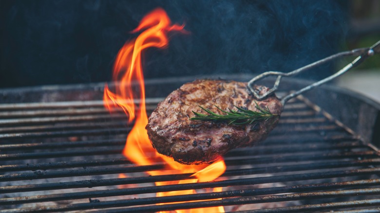 Meat being grilled over charcoal