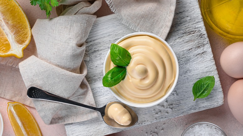 Cup of mayonnaise and cut citrus