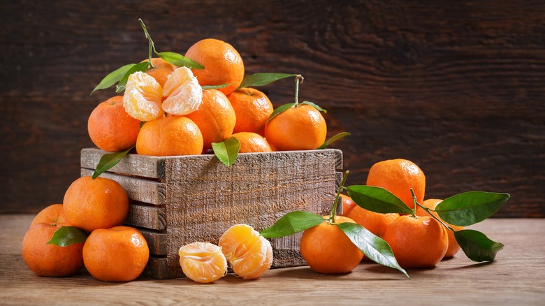Crate of tangerines, peeled and unpeeled