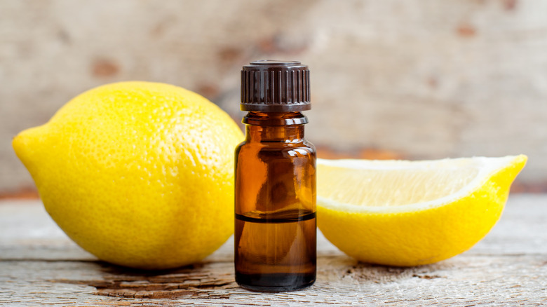 Whole and cut lemon and bottle of extract