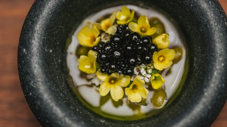 Fine dining dish with yellow flowers at Iris Norway