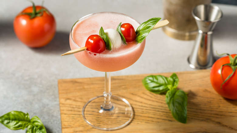 A tomato cocktail in a coupe glass